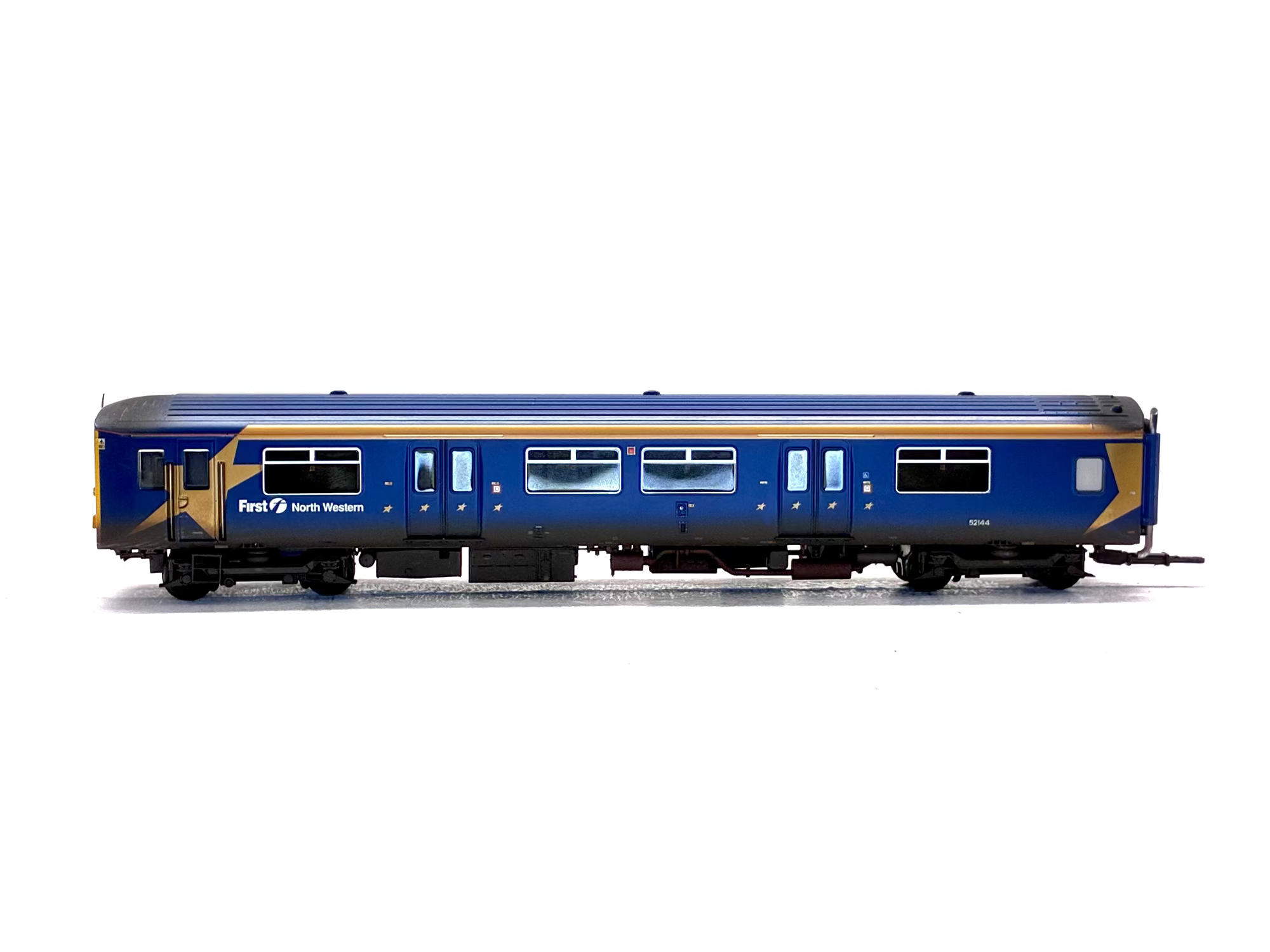 A detailed model of a blue and gold Freight North Western passenger carriage, shown in profile against a white background.