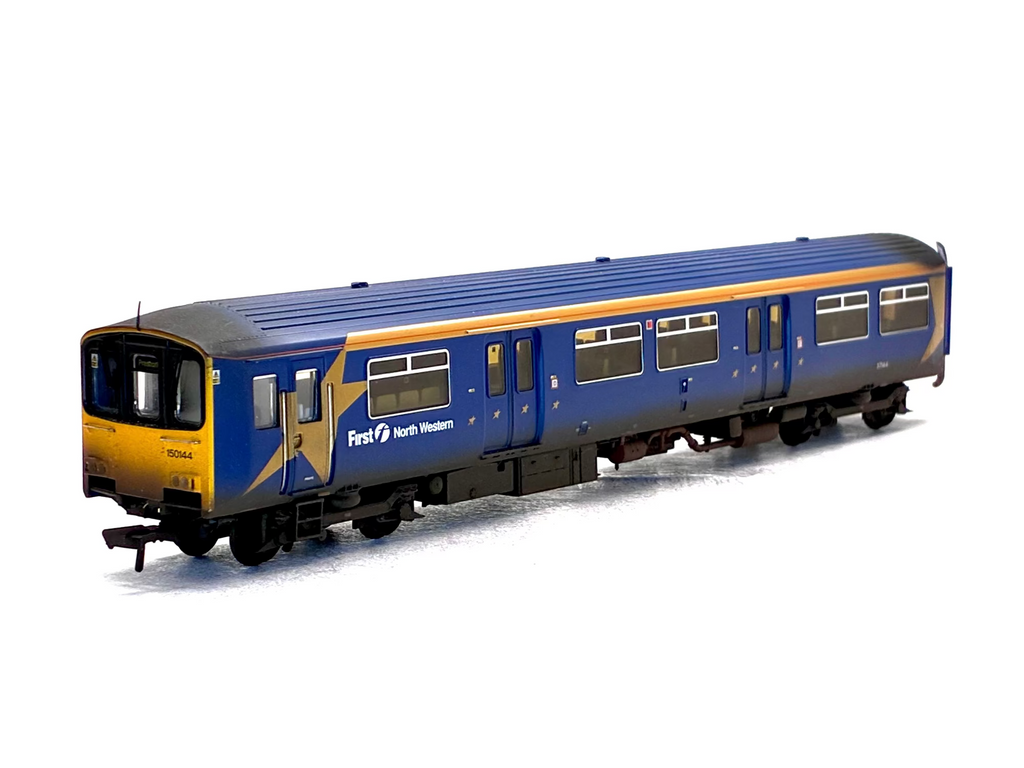 A detailed model of a First North Western blue passenger train carriage with a yellow front end and a yellow stripe along the side, shown on a white background.