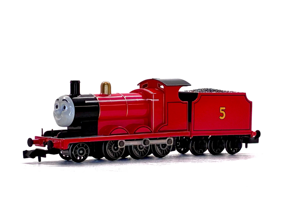 James model train engine with a smiling gray face on the front, number 5 on the side, photographed on a plain white background.