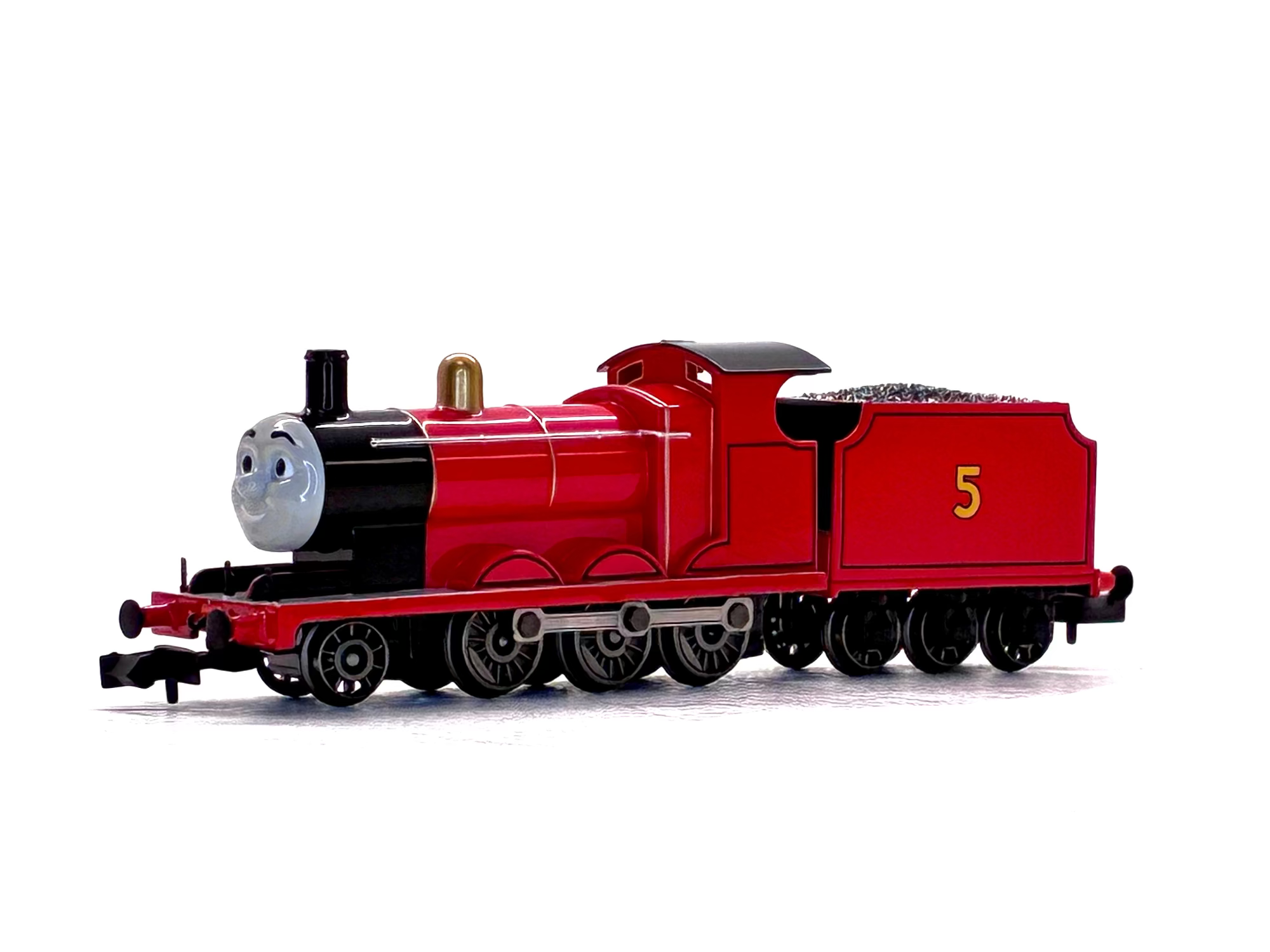 James model train engine with a smiling gray face on the front, number 5 on the side, photographed on a plain white background.
