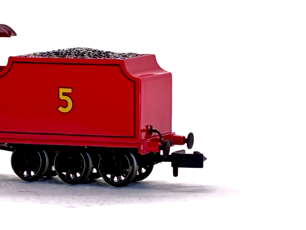 James train coal car with the number 5 in yellow, filled with black ballast, shown against a plain white background.