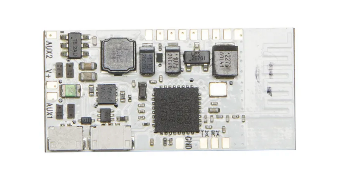 A white printed circuit board (PCB) populated with various electronic components, including a large central black integrated circuit chip, capacitors, resistors, and a USB-C connector, isolated on a white background.