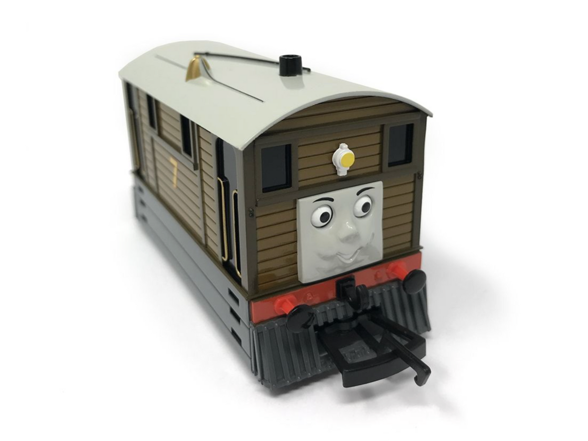 A Thomas the Tank Engine Toby toy train on a white background.