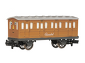 A toy model of the character Clarabel from Thomas the Tank Engine, painted in her signature orange-brown livery with a cream-colored roof and black wheels, shown against a plain white background.