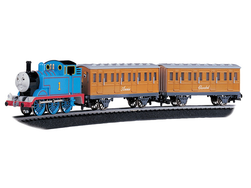 Thomas the Tank Engine model train pulling two brown passenger coaches on a black track, shown against a plain white background.