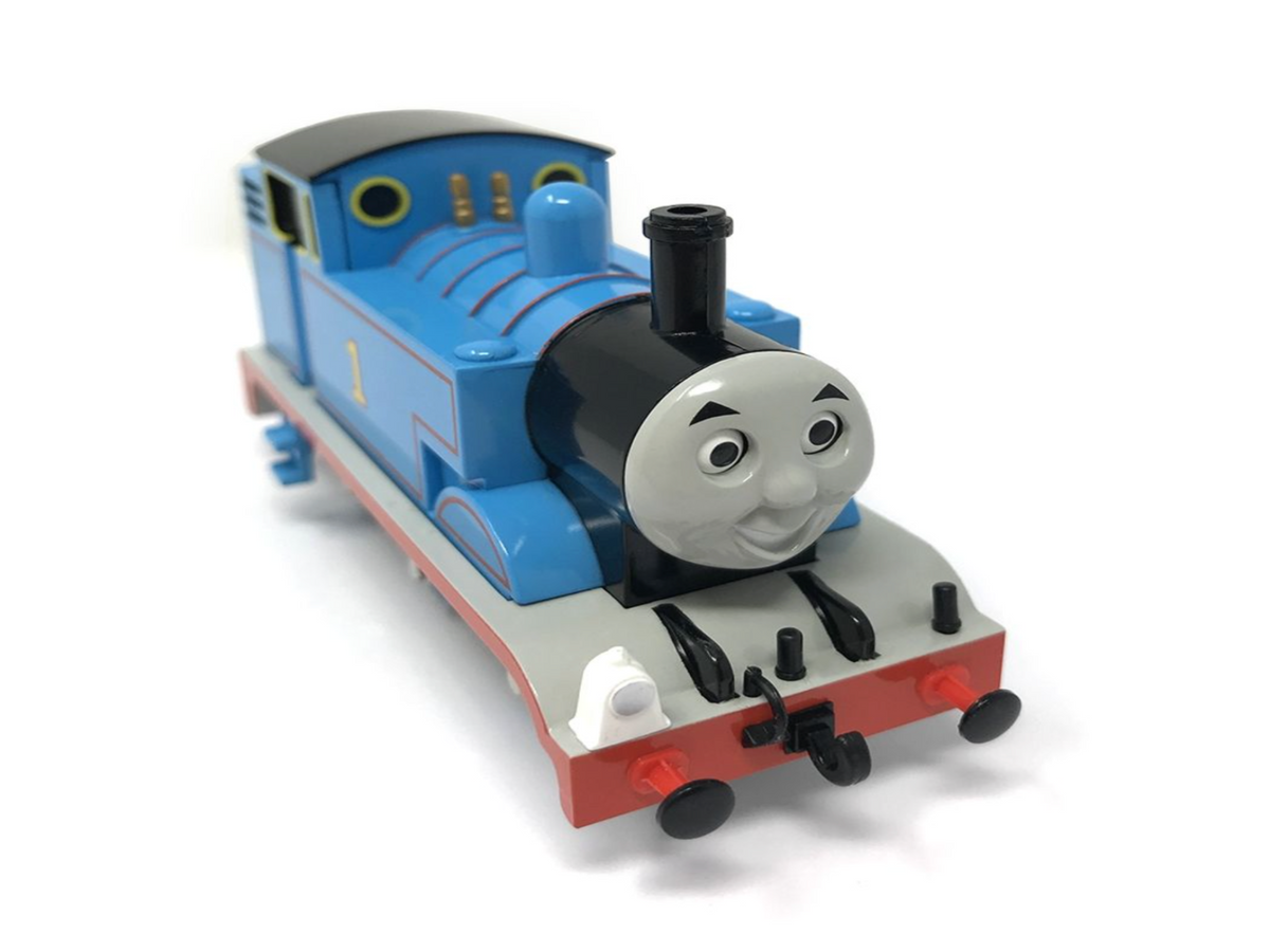Thomas the Tank Engine toy train, number 1, in blue with a black smokestack, gray face, and red undercarriage, photographed on a white background.
