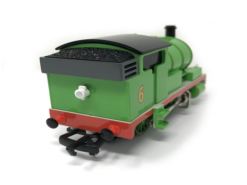 Percy green toy model train engine with the number 6 on the side, featuring a black coal bunker, red underframe, and black wheels, photographed on a white background.